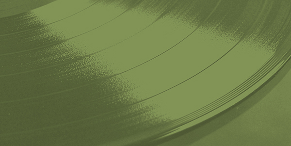 a close up of a vinyl record on an olive background