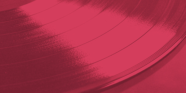 a close up of a vinyl record on a red background