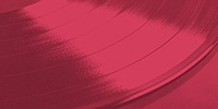 a close up of a vinyl record on a red background