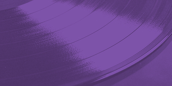 a close up of a vinyl record on a purple background