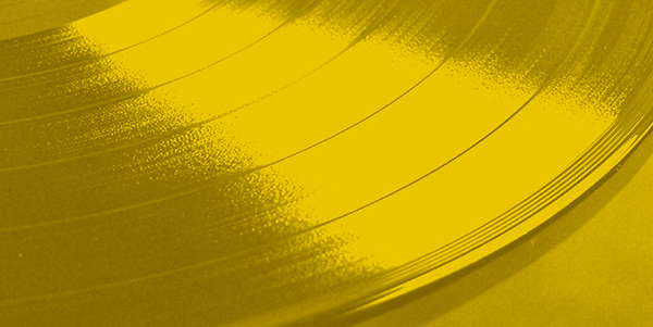 a close up of a vinyl record on a yellow background