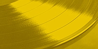 a close up of a vinyl record on a yellow background