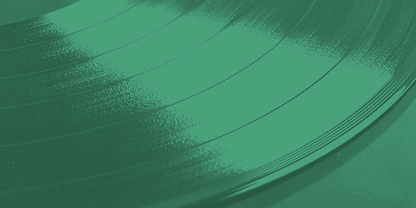 a close up of a vinyl record on a green background