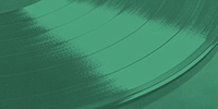 a close up of a vinyl record on a green background