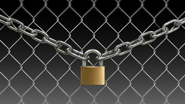 a chain link fence with a padlock across it
